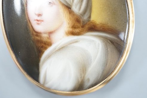 A yellow metal mounted porcelain miniature oval brooch, painted with a young boy, 64mm, gross weight 25.1 grams.